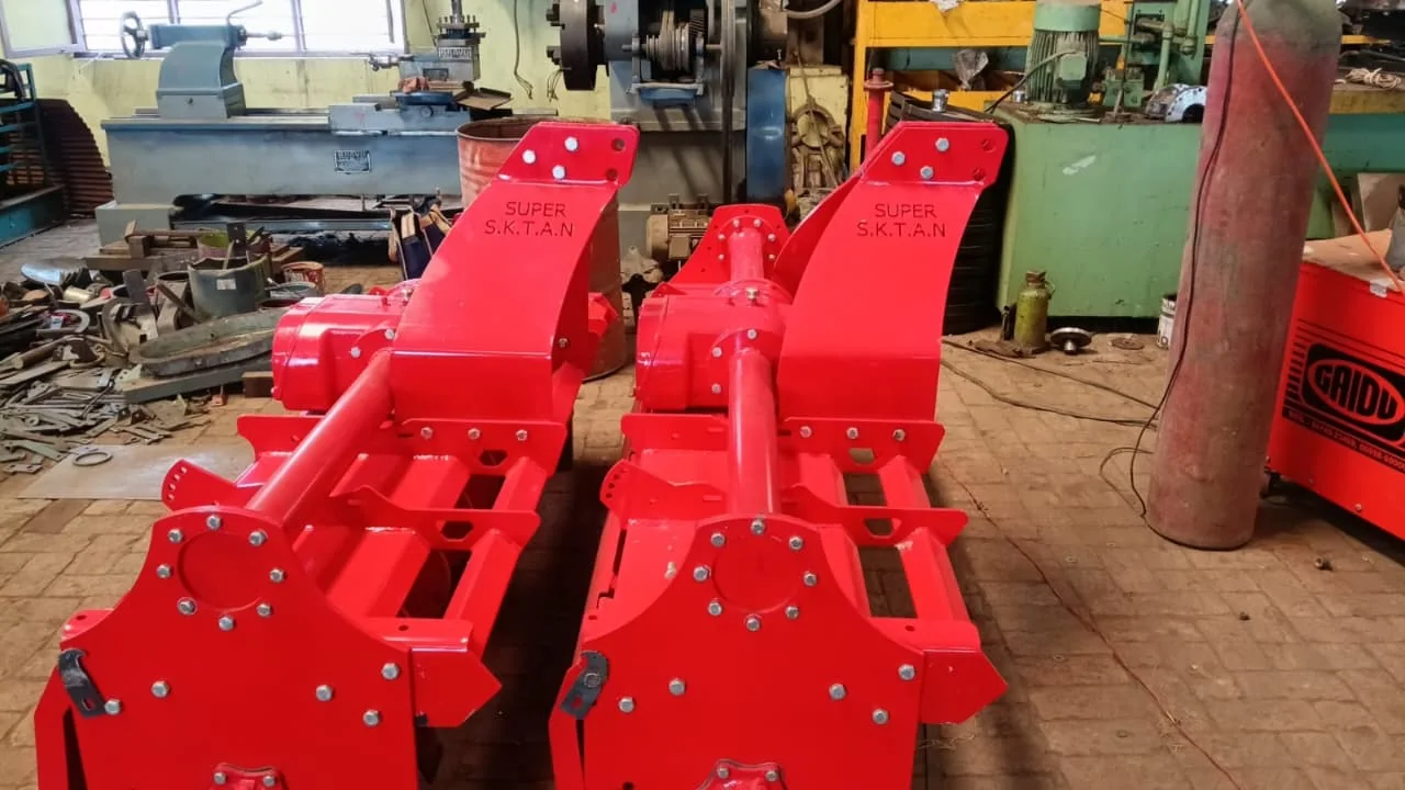 Red rotavators inside workshop